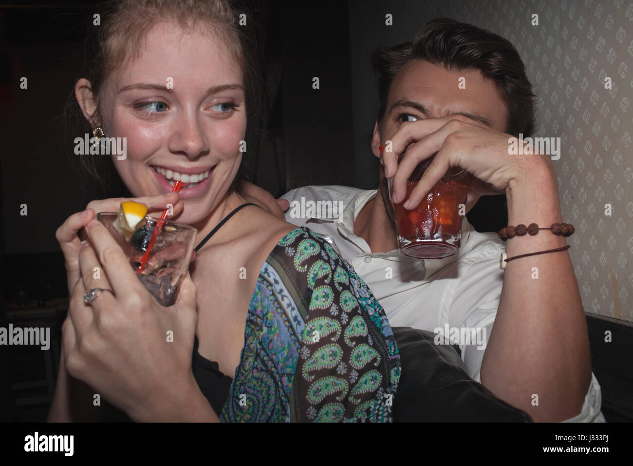 Friends hanging out at a nightclub Stock Photo - Alamy