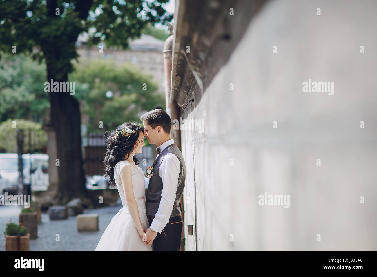 bride and groom walking in old city Stock Photo - Alamy