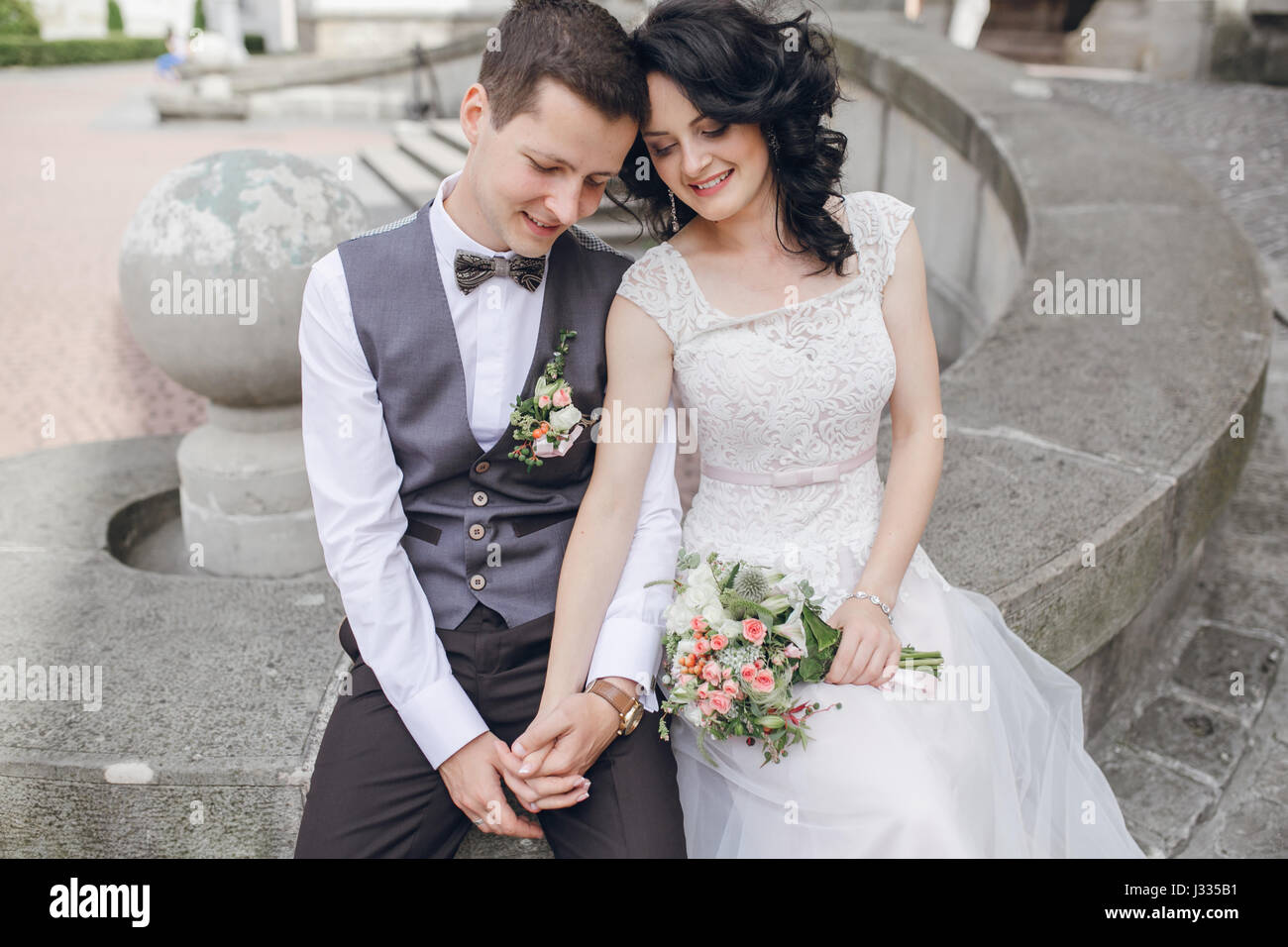 bride and groom sitting in the yard Stock Photo - Alamy