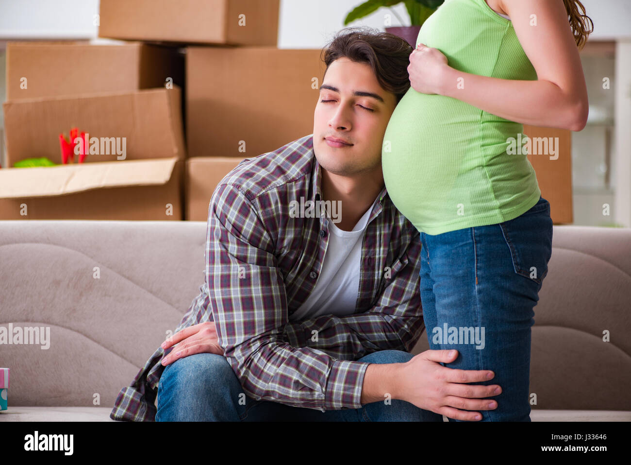Man Expecting Young couple of man and pregnant wife expecting baby Stock Photo - Alamy