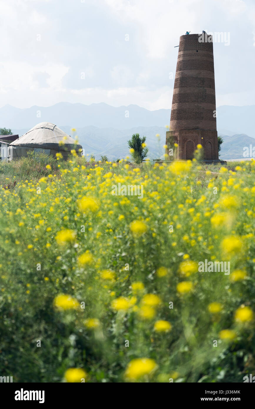 The Burana Tower is a large minaret in the Chuy Valley in northern Kyrgyzstan, which dates to the 10th century from the ancient city of Balasagun. Stock Photo