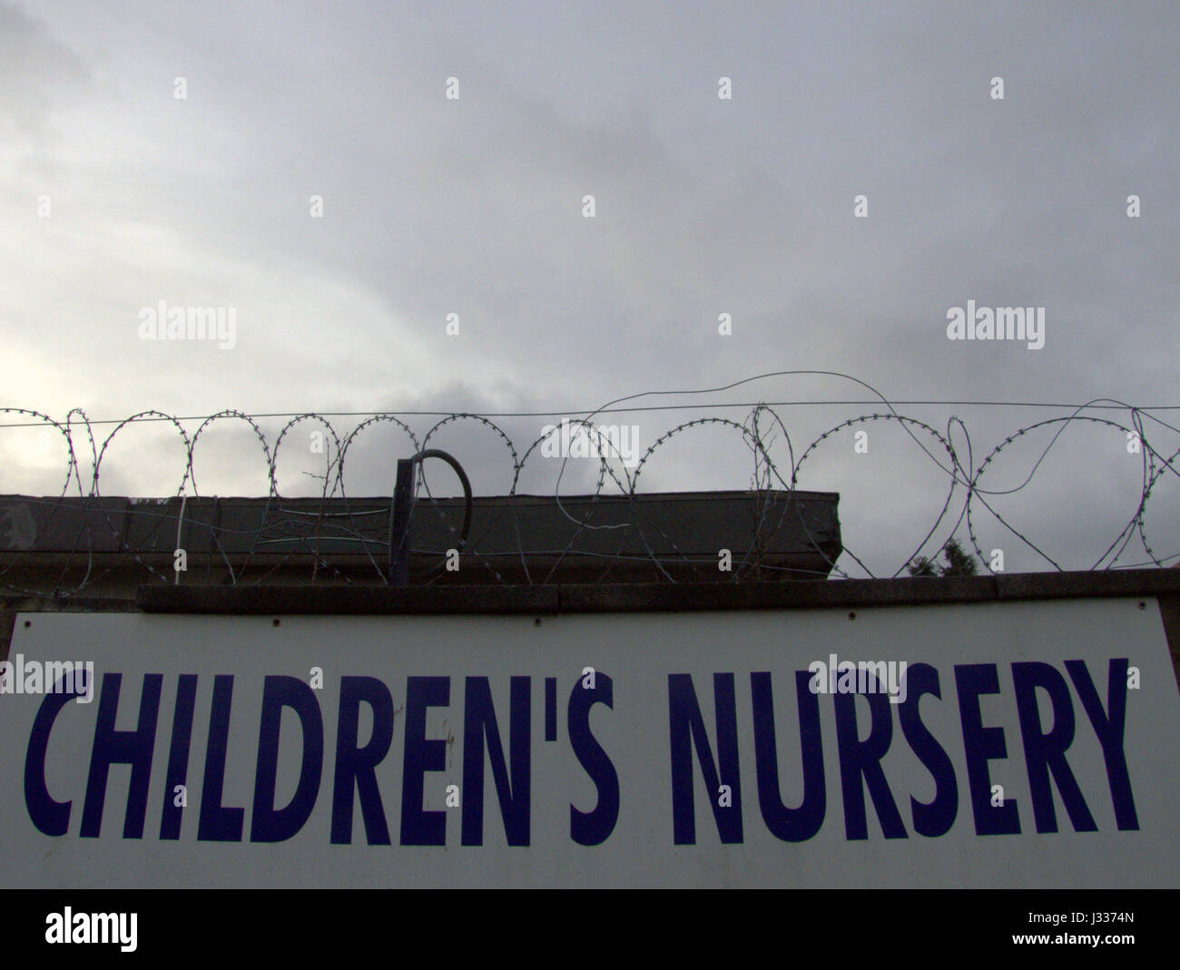 children's nursery sign uninviting bad Ayn Rand dark cloudy sky Stock Photo