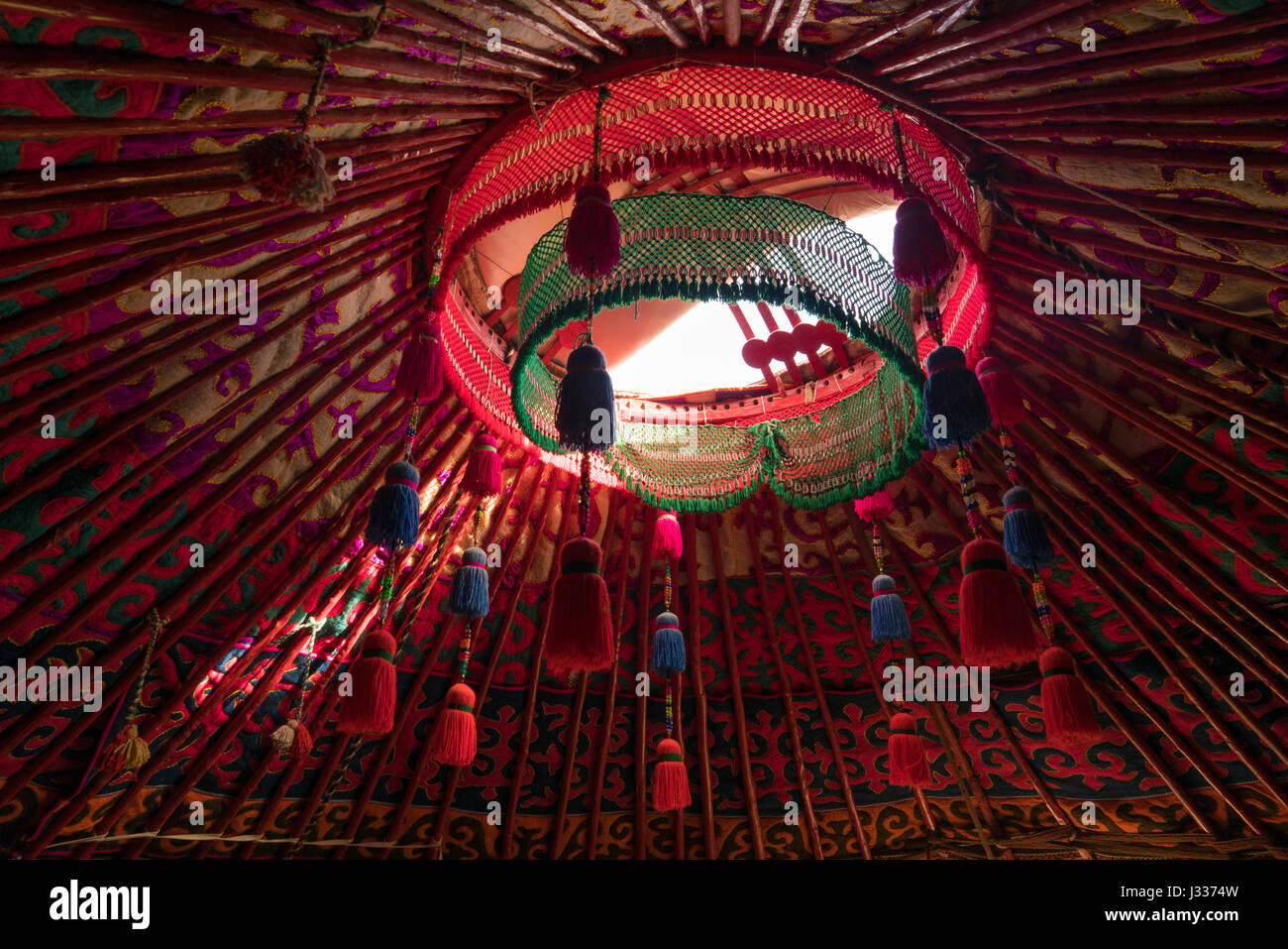 Red felt ornaments in the roof of a Kyrgyz yurt Stock Photo