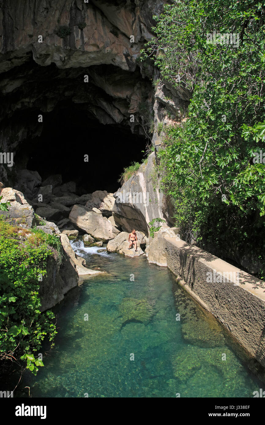 Person exploring entrance ot cave, Cueva del Gato, Benaojan, Serrania de  Ronda, Malaga province, Spain Stock Photo - Alamy