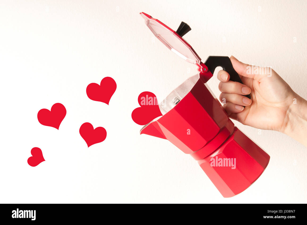 hand holding a coffee maker and hearts coming out of it, love for coffee concept Stock Photo
