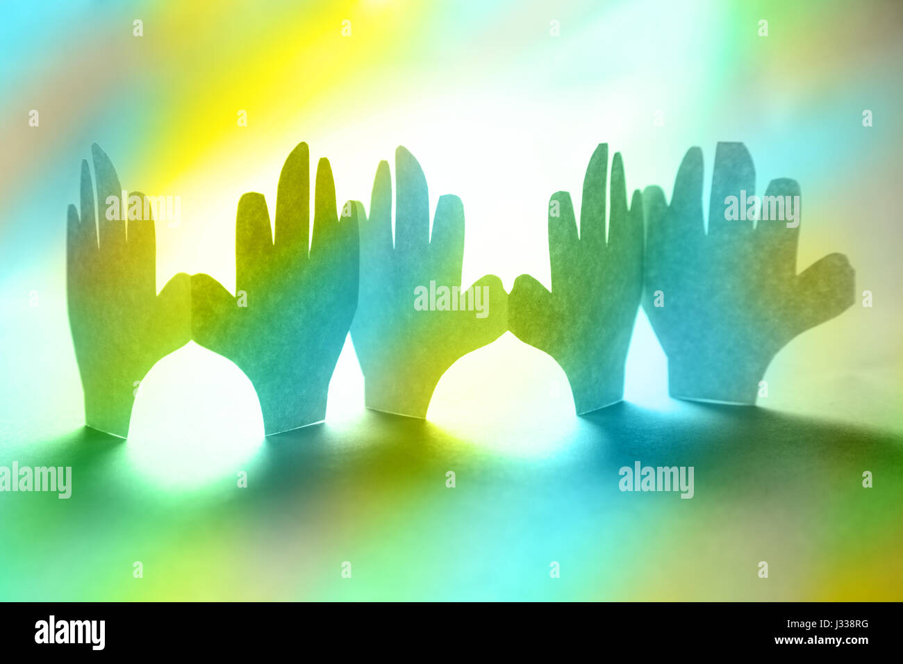 Paper hands in connection as friendship symbol Stock Photo