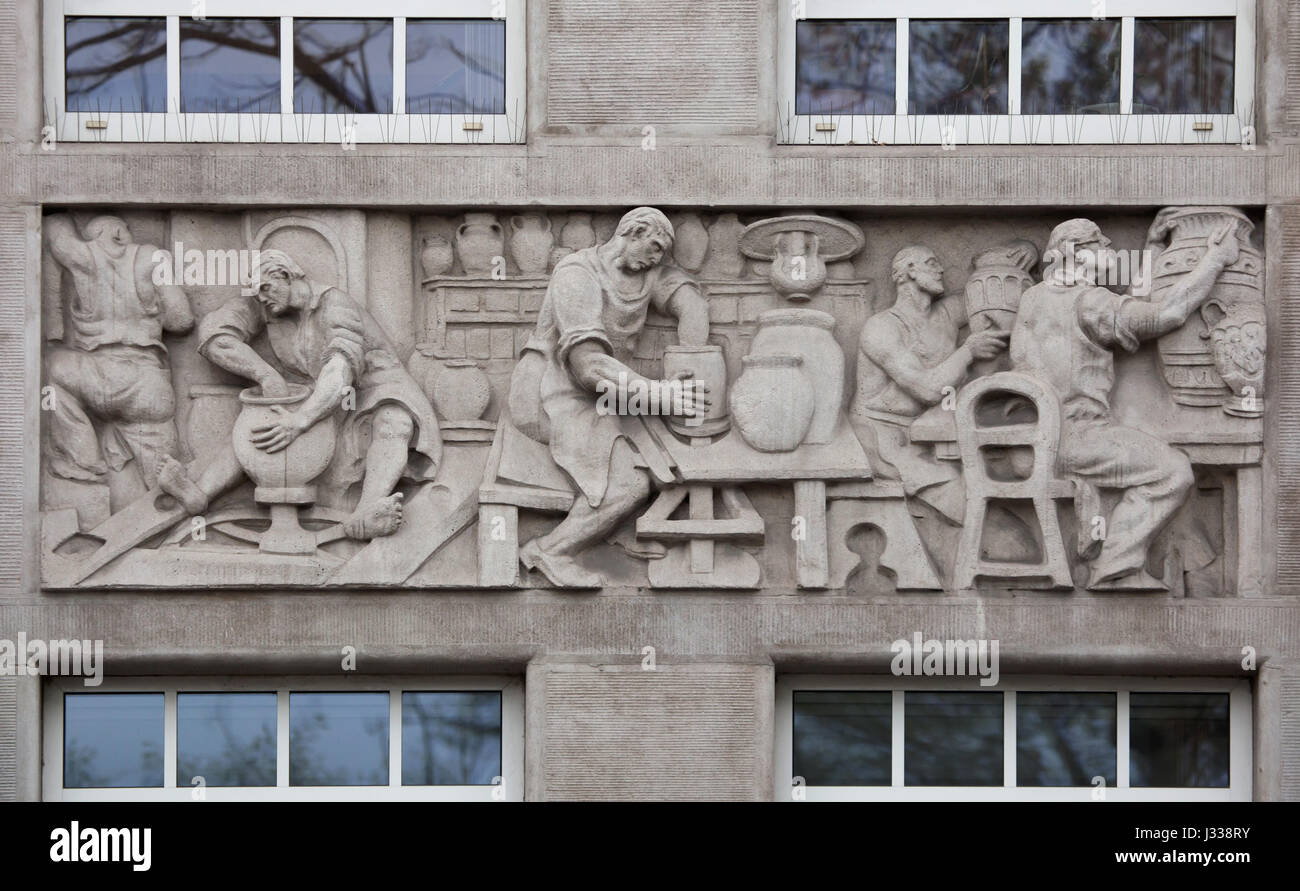 Pottery production. Relief by Hungarian sculptor Laszlo Huvos (1930) on the north wing of the Art Deco building of the Budapest Workers Insurance Fund in Budapest, Hungary. The building, now used as the seat of the National Social Insurance Centre (OTI), was designed by Hungarian architects Marcell Komor and Dezso Jakab and built in 1913. The north wing was added by architect Aladar Sos in 1930-1931. Stock Photo
