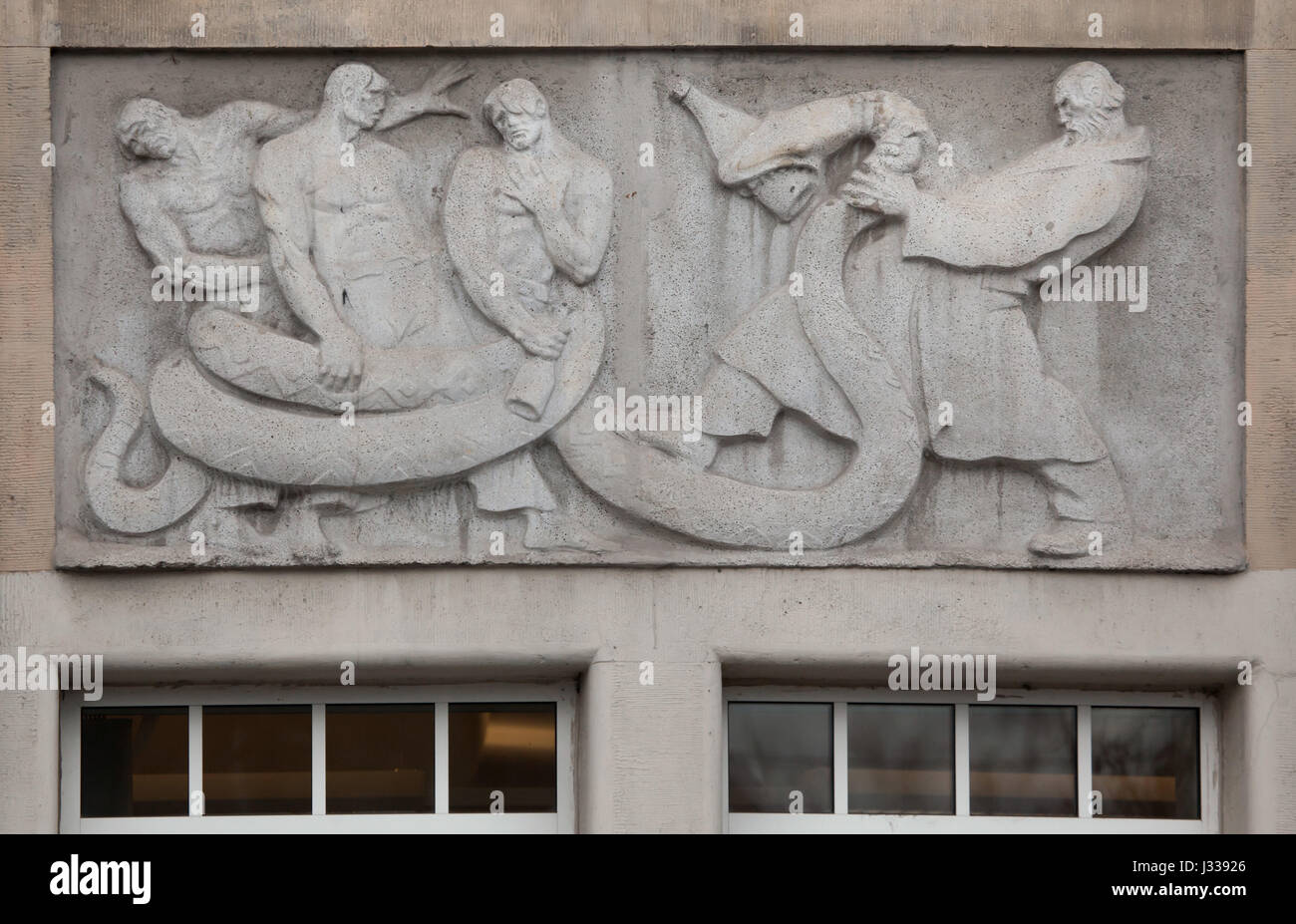 Fighting with the alcohol dependence syndrome. Relief by Hungarian sculptor Mihaly Biro on the south wing of the Art Nouveau building of the Budapest Workers Insurance Fund in Budapest, Hungary. The building, now used as the seat of the National Social Insurance Centre (OTI), was designed by Hungarian architects Marcell Komor and Dezso Jakab and built in 1913. The north wing was added in the 1930s. Stock Photo