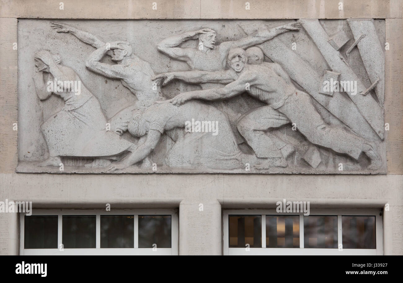 Industrial accident. Relief by Hungarian sculptor Mihaly Biro on the south wing of the Art Nouveau building of the Budapest Workers Insurance Fund in Budapest, Hungary. The building, now used as the seat of the National Social Insurance Centre (OTI), was designed by Hungarian architects Marcell Komor and Dezso Jakab and built in 1913. The north wing was added in the 1930s. Stock Photo