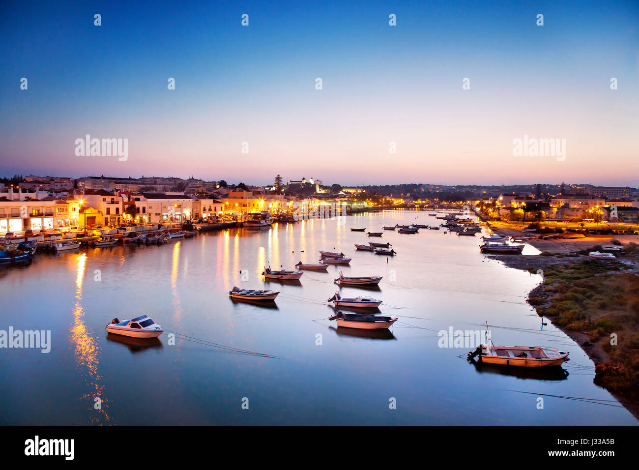 View towards Tavira und Rio Gilao at dusk, Tavira, Algarve, Portugal Stock Photo
