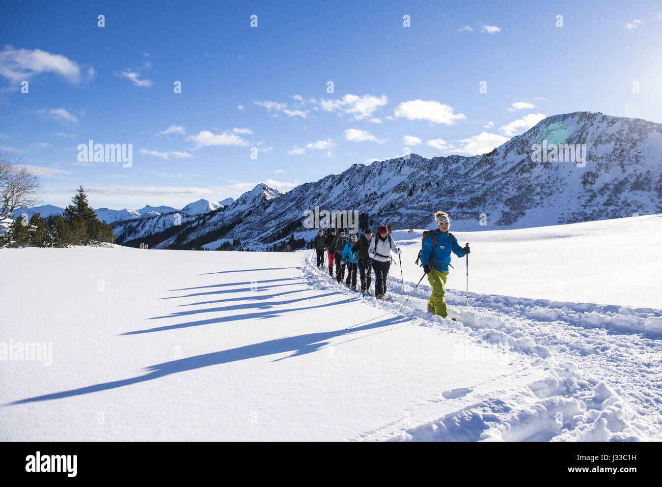 Group of hikers snowshoeing, Schwarzwasser valley in sunshine, Vorarlberg, Austria Stock Photo