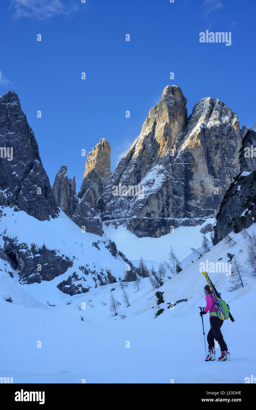 Female back-country skier ascending to Hochbrunnerschneid, Sexten Dolomites, South Tyrol, Italy Stock Photo
