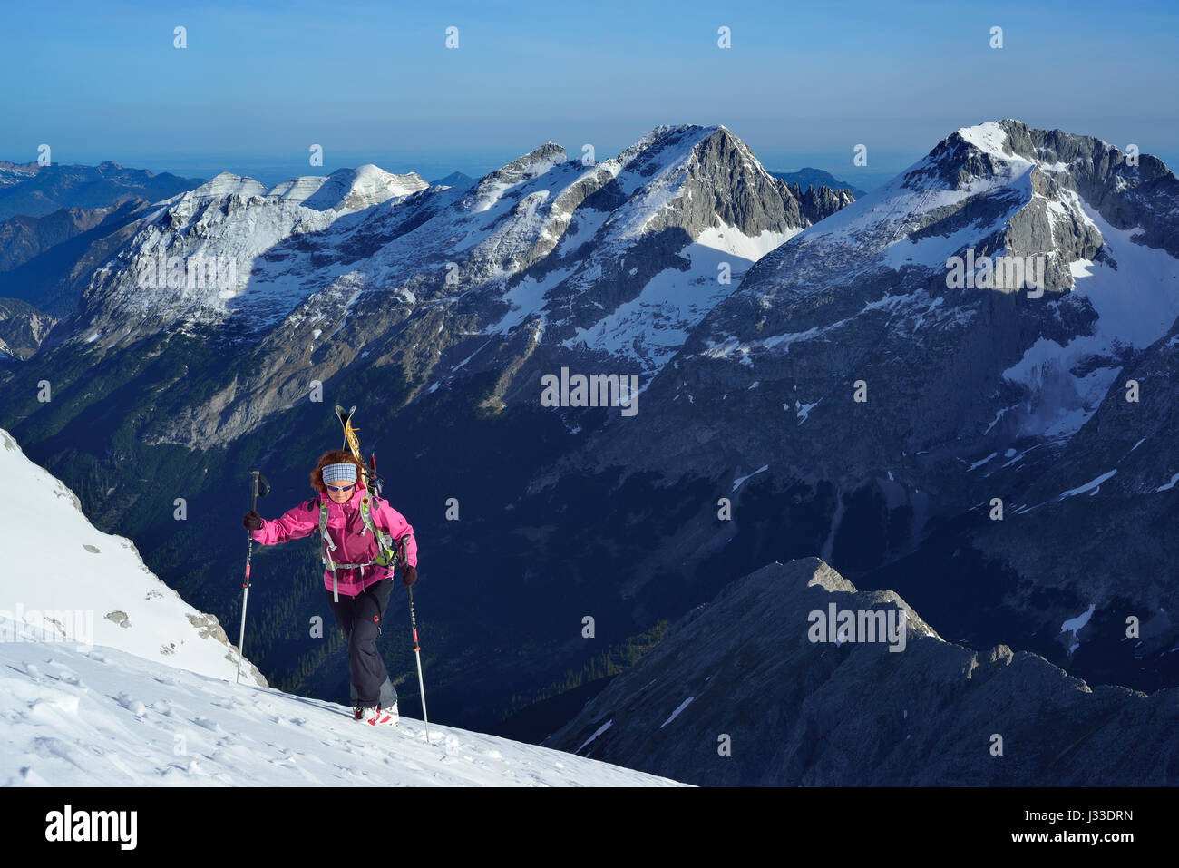 Female back-country skier ascending to Birkkarspitze, Karwendel range, Tyrol, Austria Stock Photo