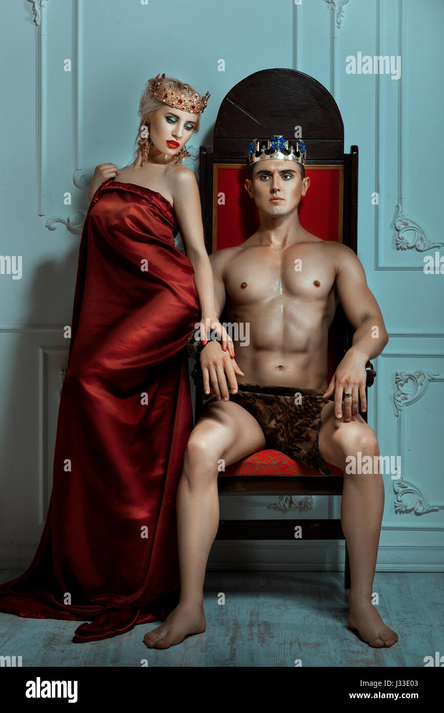 Man king sitting on the throne beside the Queen is a woman. Man is strong and overbearing. Stock Photo