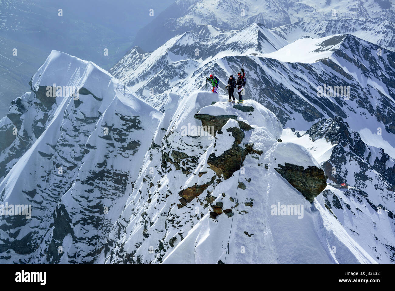 Three persons standing on summit of Kleinglockner, Grossglockner, Glockner Group, Hohe Tauern National Park, East Tyrol, Tyrol, Austria Stock Photo