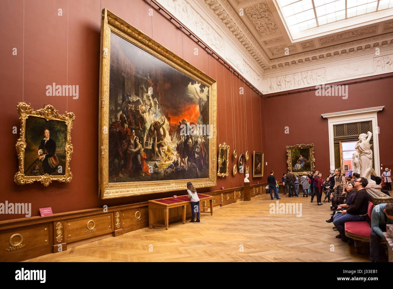 ST. PETERSBURG, RUSSIA - CIRCA APR, 2017: People sit at the benches near picture of 'The Last Day of Pompeii', artist Karl Bryullov. Interior of the S Stock Photo