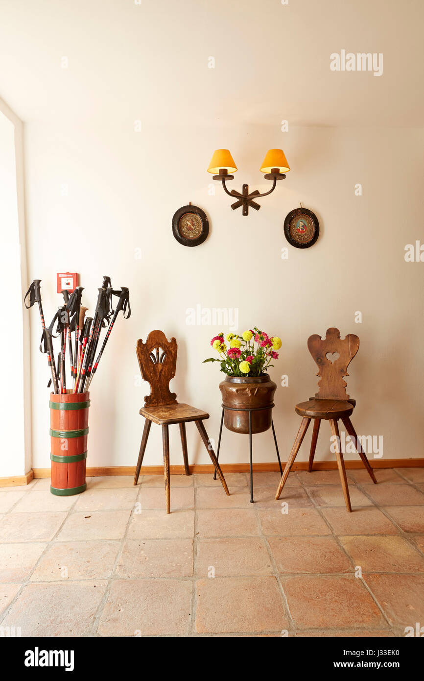 Hiking sticks and chairs at Hotel Gasthof Bad Dreikirchen, mountain hotel owned by the Wodenegg family, Eisack Valley, Trechiese 12, Barbian, South Tyrol, Italy Stock Photo