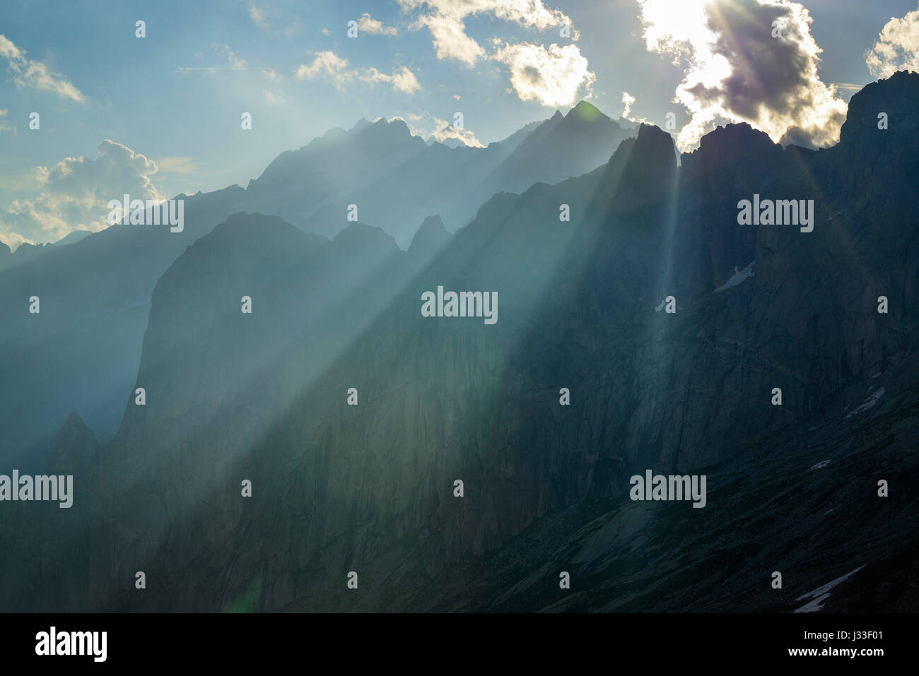 Beams of light over pinnacles, Sentiero Roma, Bergell range, Lombardy, Italy Stock Photo