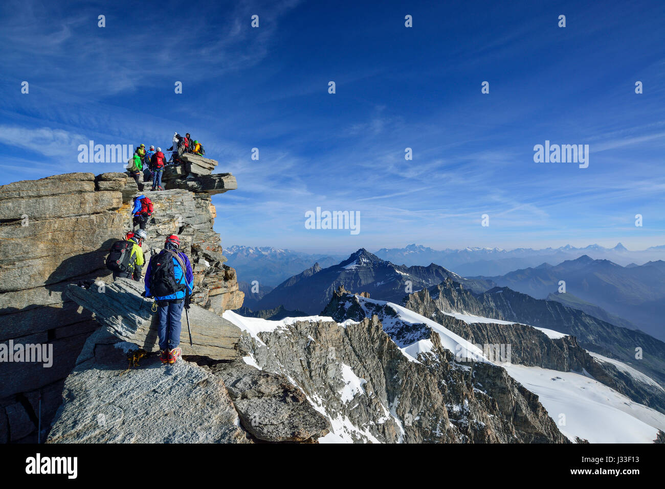 Several persons ascending on ridge to Gran Paradiso, Gran Paradiso, Gran Paradiso Nationalpark, Graian Alps range, valley of Aosta, Aosta, Italy Stock Photo