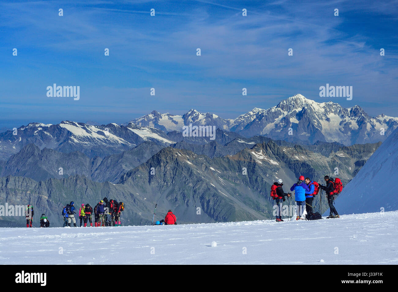 Several groups of persons standing on glacier of Gran Paradiso, Gran Paradiso, Gran Paradiso Nationalpark, Graian Alps range, valley of Aosta, Aosta, Italy Stock Photo