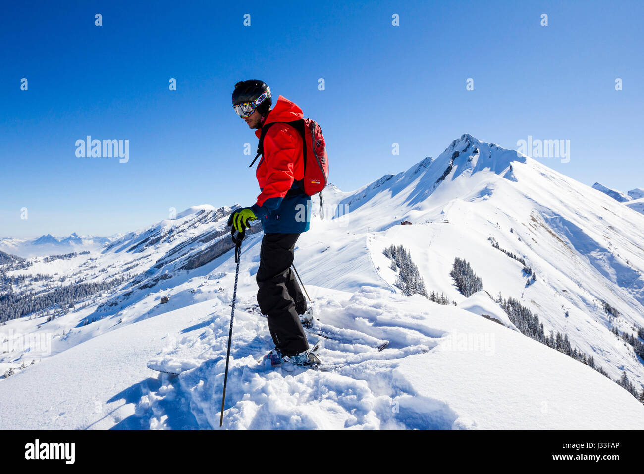 Skier standing on a mountain top, free ride skiing area Haldigrat, Niederrickenbach, Oberdorf, Canton of Nidwalden, Switzerland Stock Photo