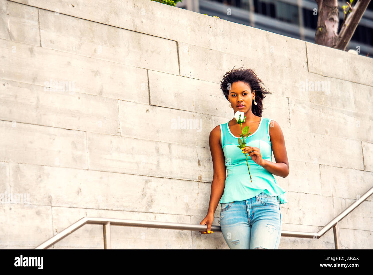 Young girl wearing green top and jeans 