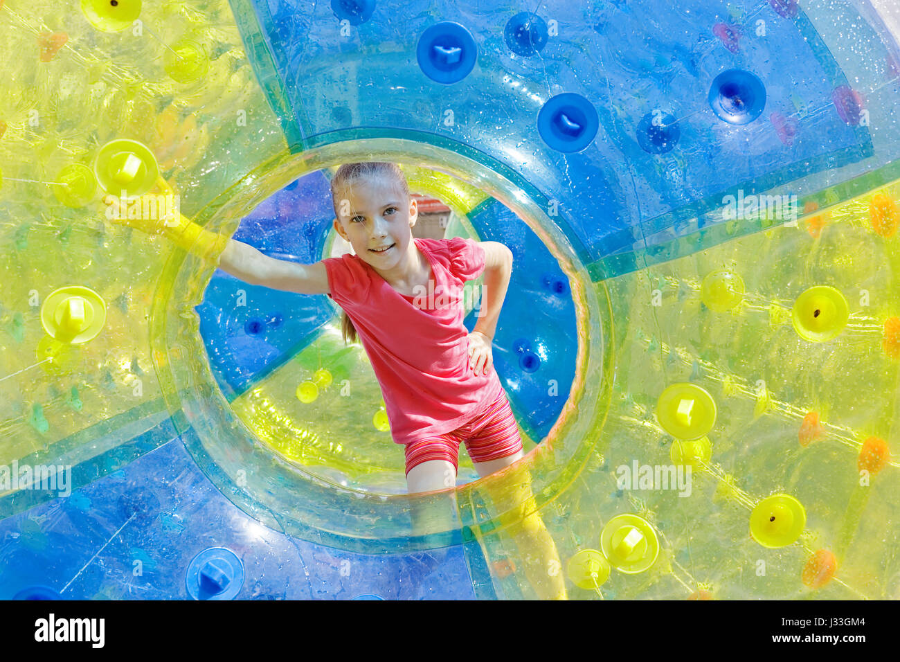Young Inflatable Zorbing. Joyful girl teen inside the inflatable cylinder outdoor Stock ...