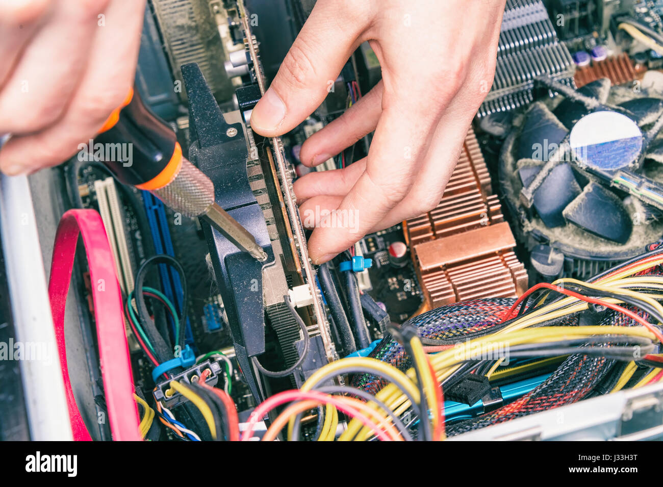 Man fixing an old desktop computer using a screwdriver Stock Photo Alamy
