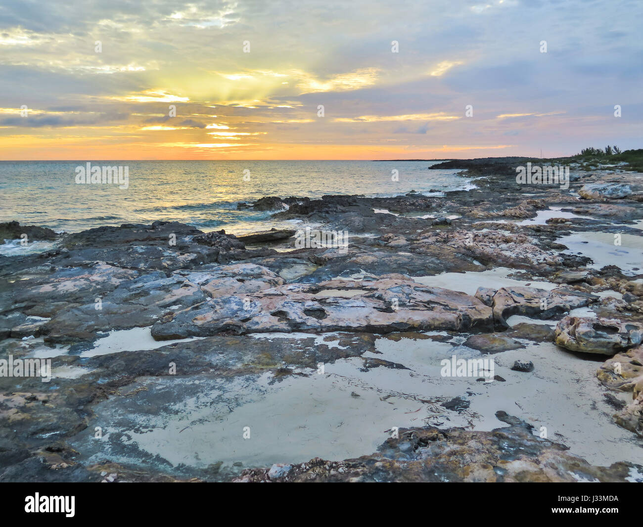 Rocky beach at sun set, in Gun Cay, Bahamas. Stock Photo