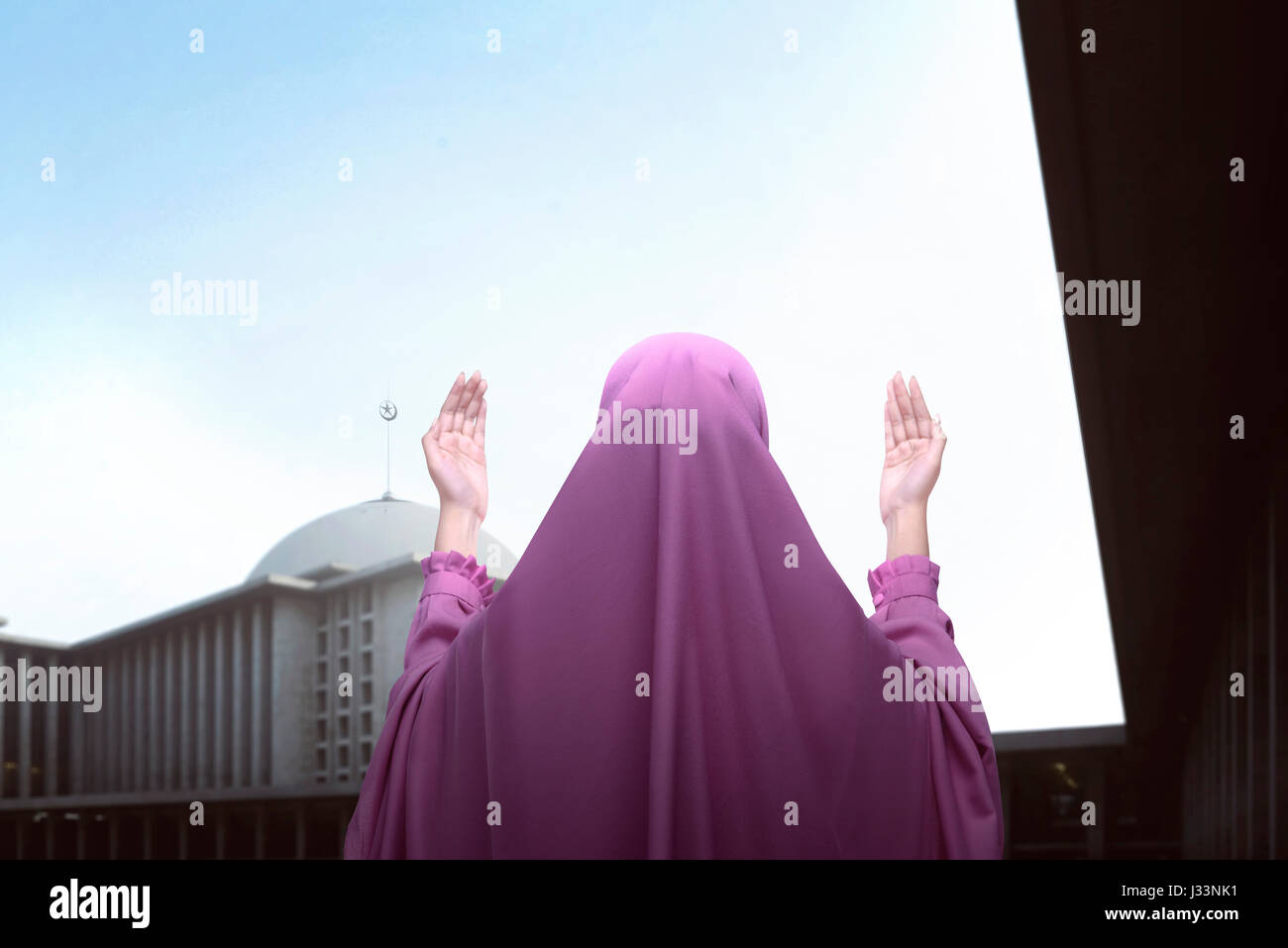 Rear view of asian muslim woman praying in the mosque Stock Photo - Alamy