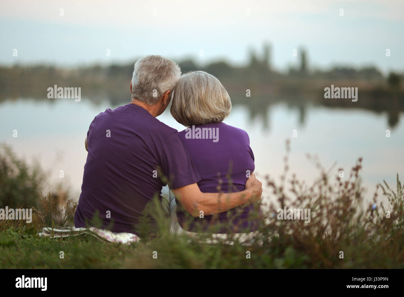 Happy senior couple sitting Stock Photo - Alamy