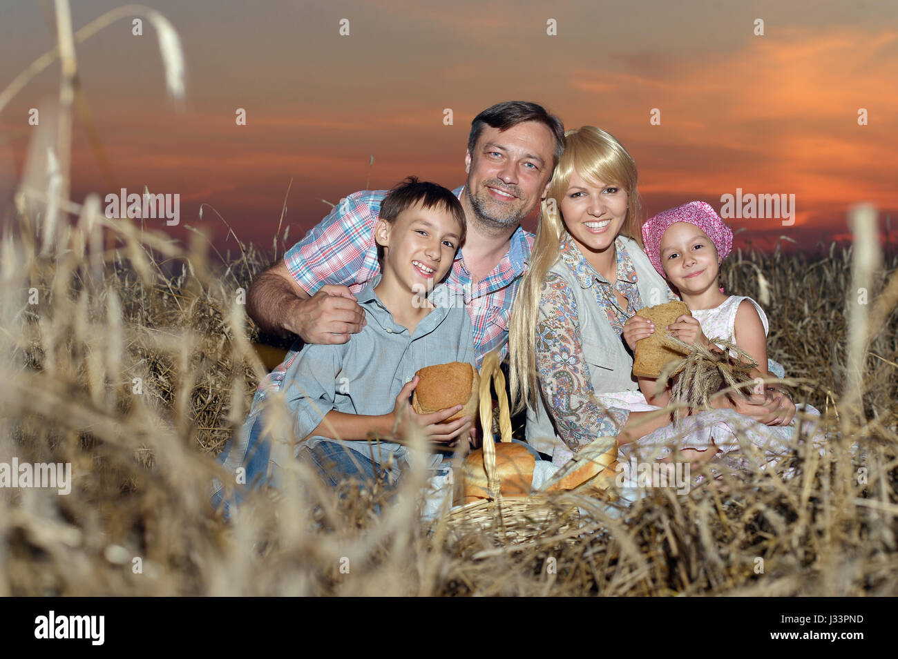 Happy parents with children at sunset Stock Photo