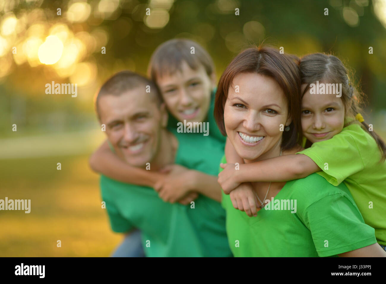 Happy parents with children at sunset Stock Photo