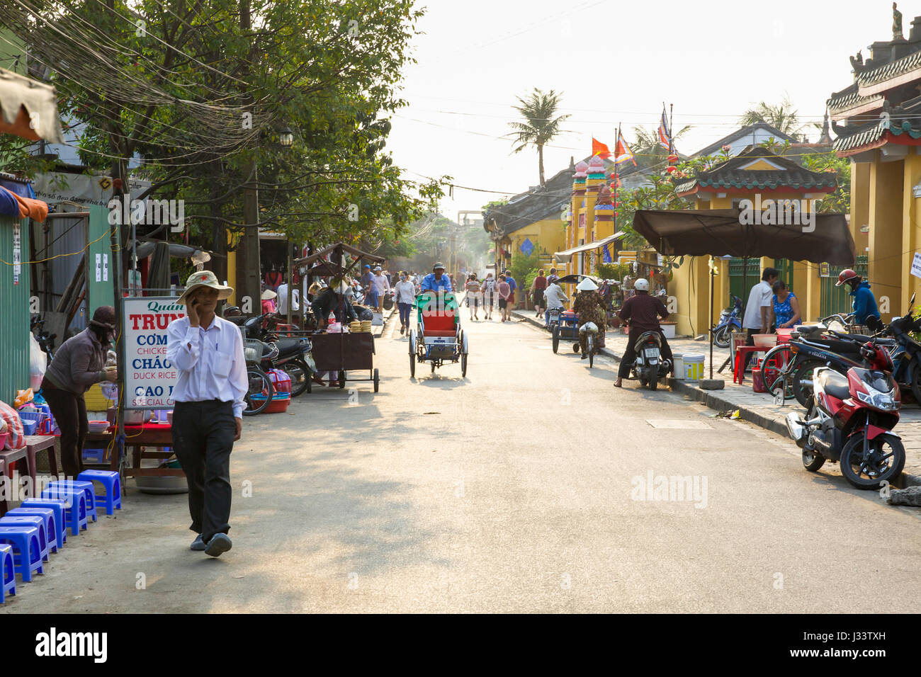 HOI AN, VIETNAM - MARCH 13: People on the street of Hoi An ancient town, UNESCO World Heritage Site on March 13, 2014 in Hoi An, Vietnam. Stock Photo