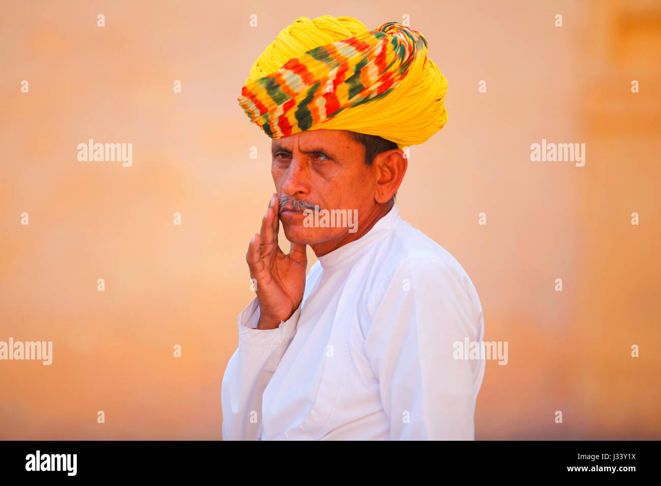 Rajasthani man with yellow turban inside the 'Mehrangarh fort'. Jodhpur, India. Stock Photo