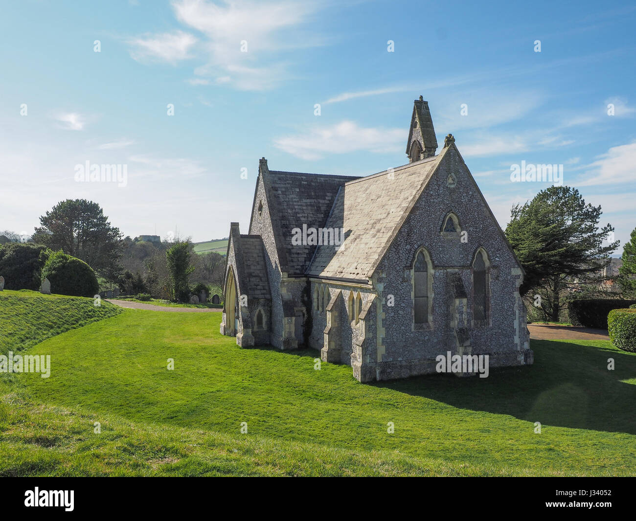 Mount Joy Cemetery Chapel Newport Isle of Wight sunny day light wispy cloud grass lawn in foreground strong shadow Stock Photo