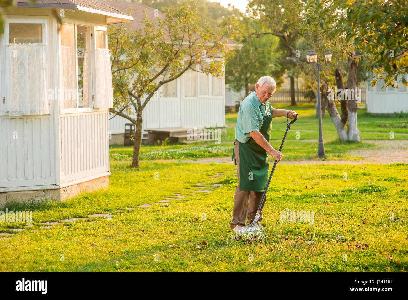 Senior with rake hi-res stock photography and images - Alamy