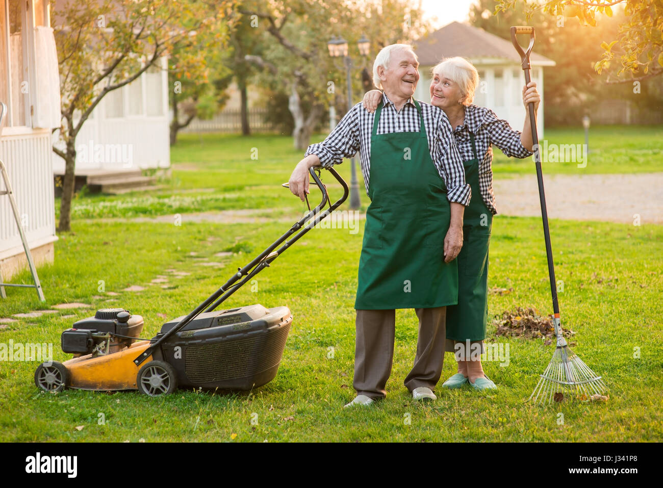Smiling couple of old gardeners. Stock Photo