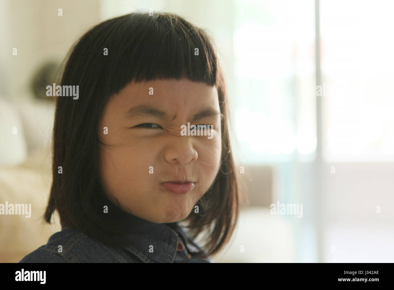 funny face of asian little girl Stock Photo - Alamy
