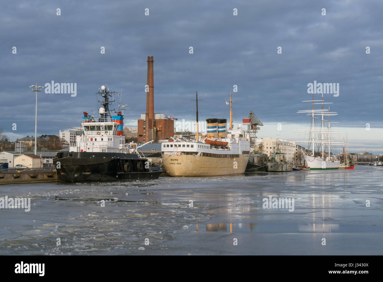 Turku and Swan of Finland (Suomen Joutsen) seen at the mouth of Aura river in February 2017, Finland Stock Photo