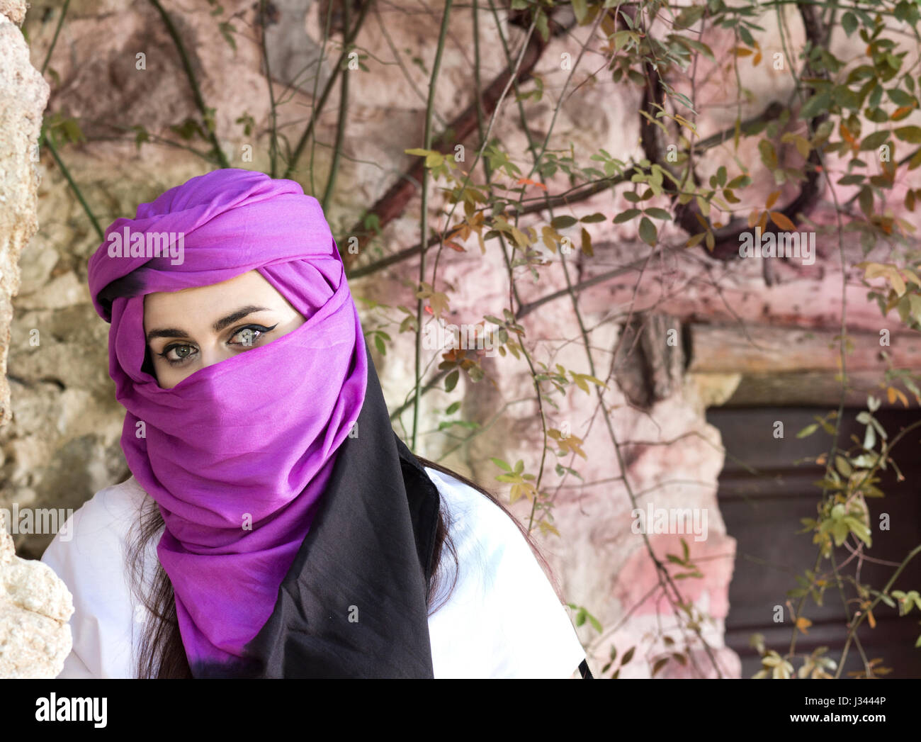 Portrait of beautiful and enigmatic young woman wearing hiyab looking at camera. Stock Photo