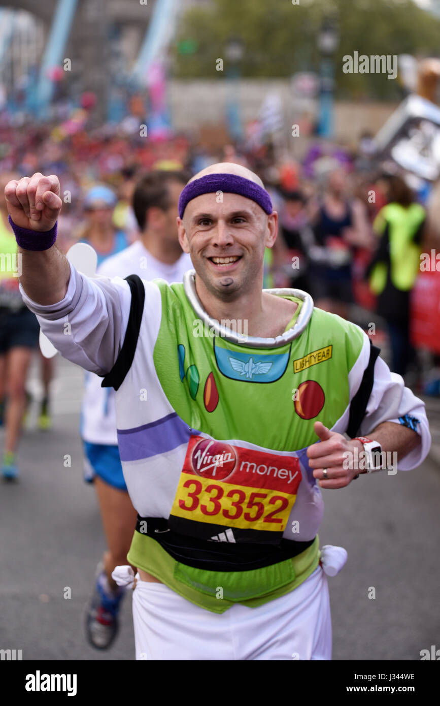 Iestyn Rhodes running in a Buzz Lightyear costume in the 2017 London Marathon near Tower Bridge Stock Photo