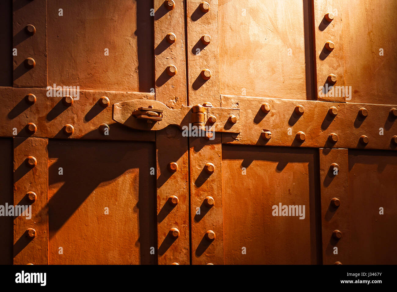 Part of industrial container red door , with a sword pattern Stock Photo