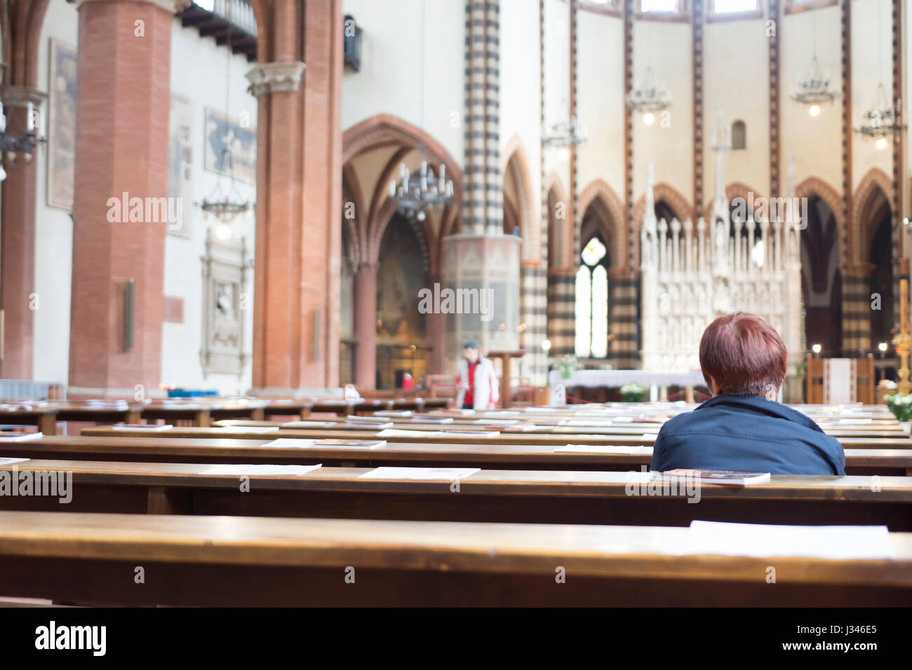 A faithful alone pray in a church Stock Photo