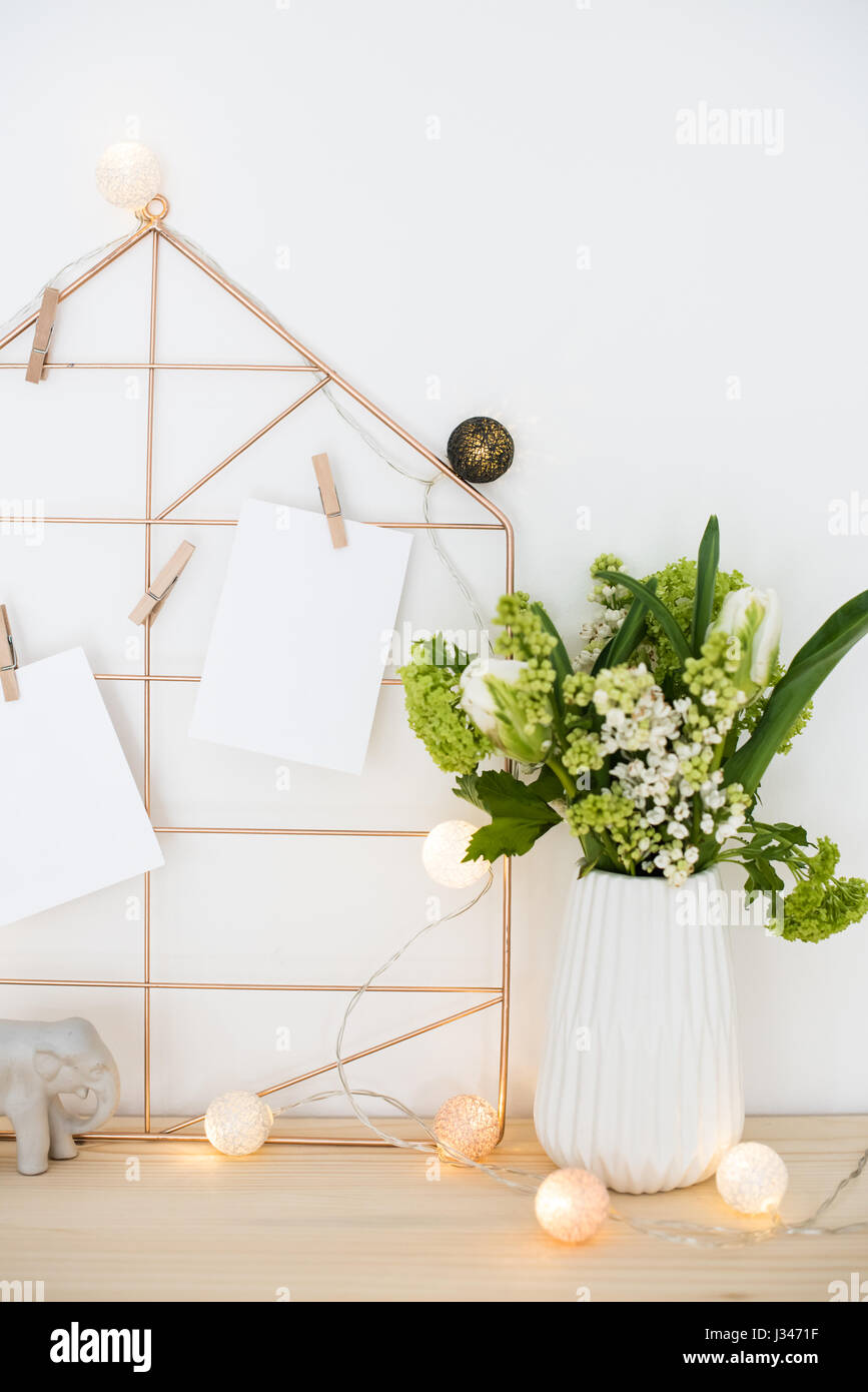 Feminine hipster office table decoration with flowers and mood board on