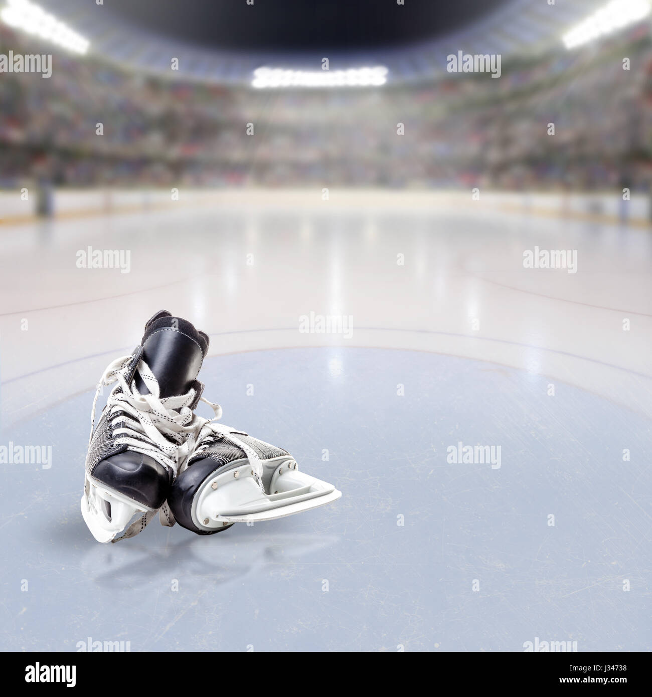 Pair of hockey skates on ice in fictitious arena with fans in the stands and copy space. 3D rendering of hockey rink arena. Stock Photo