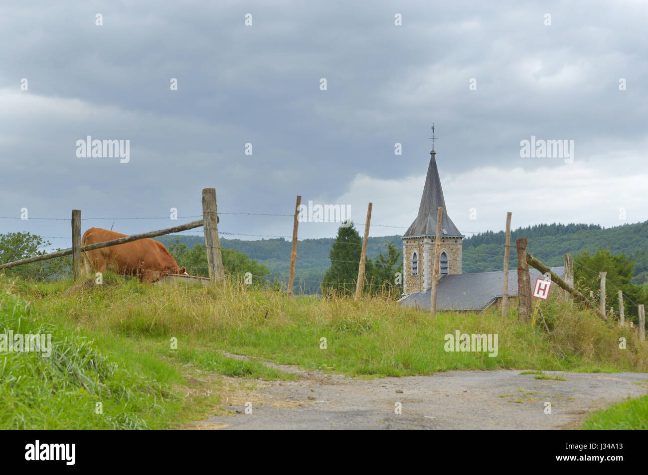 Eglise Saint-Jean-Baptiste of Fanzel in a Ardennes landscape Stock Photo
