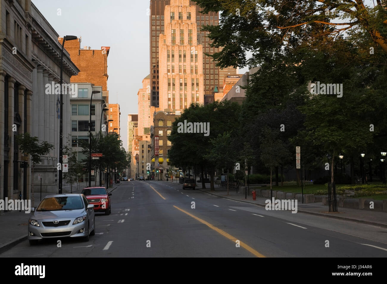 Notre-Dame Street without traffic looking Westward at Dawn, Old Montreal, Quebec, Canada Stock Photo