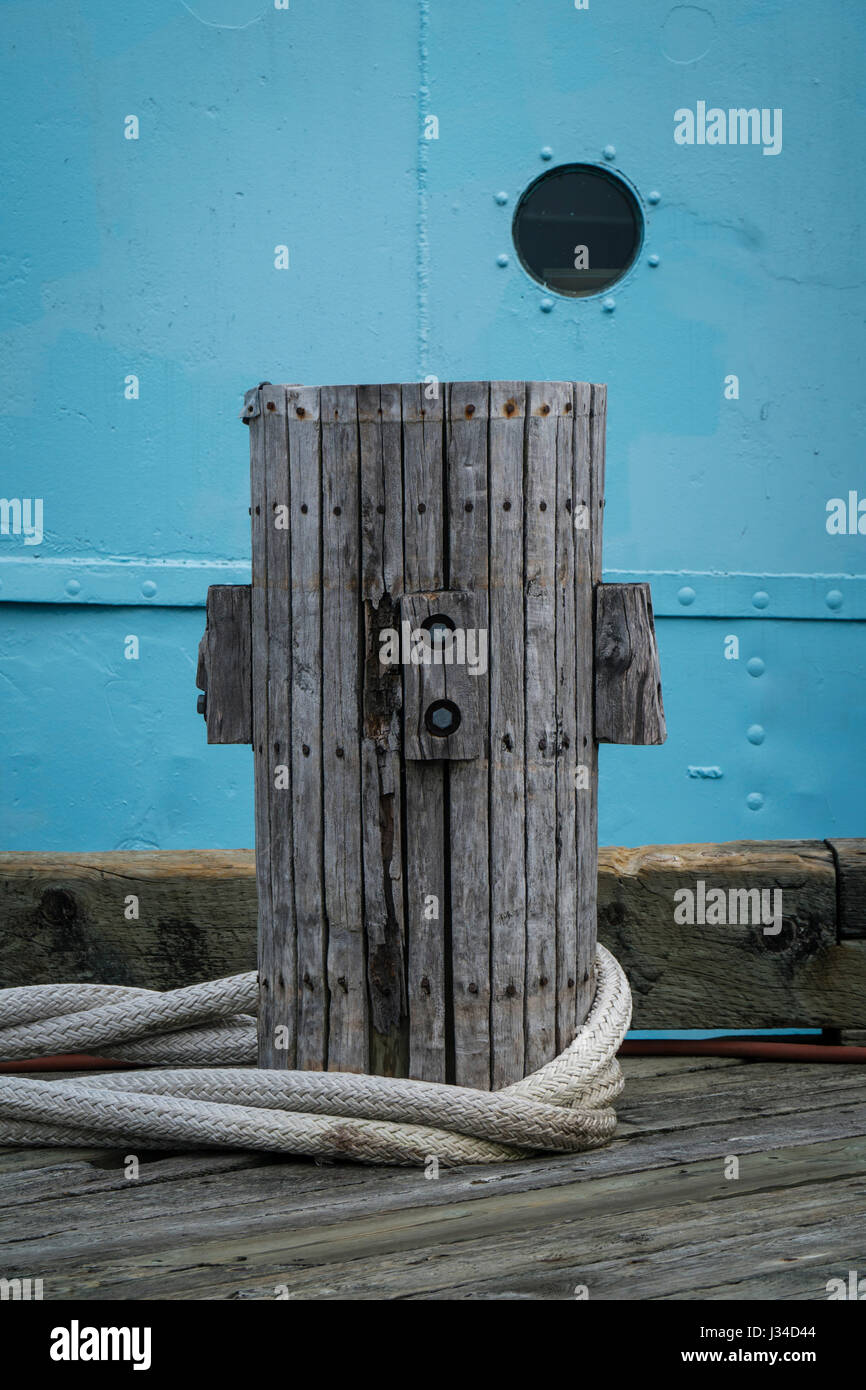 Porthole in ship's hull behind wharf bollard Stock Photo Alamy