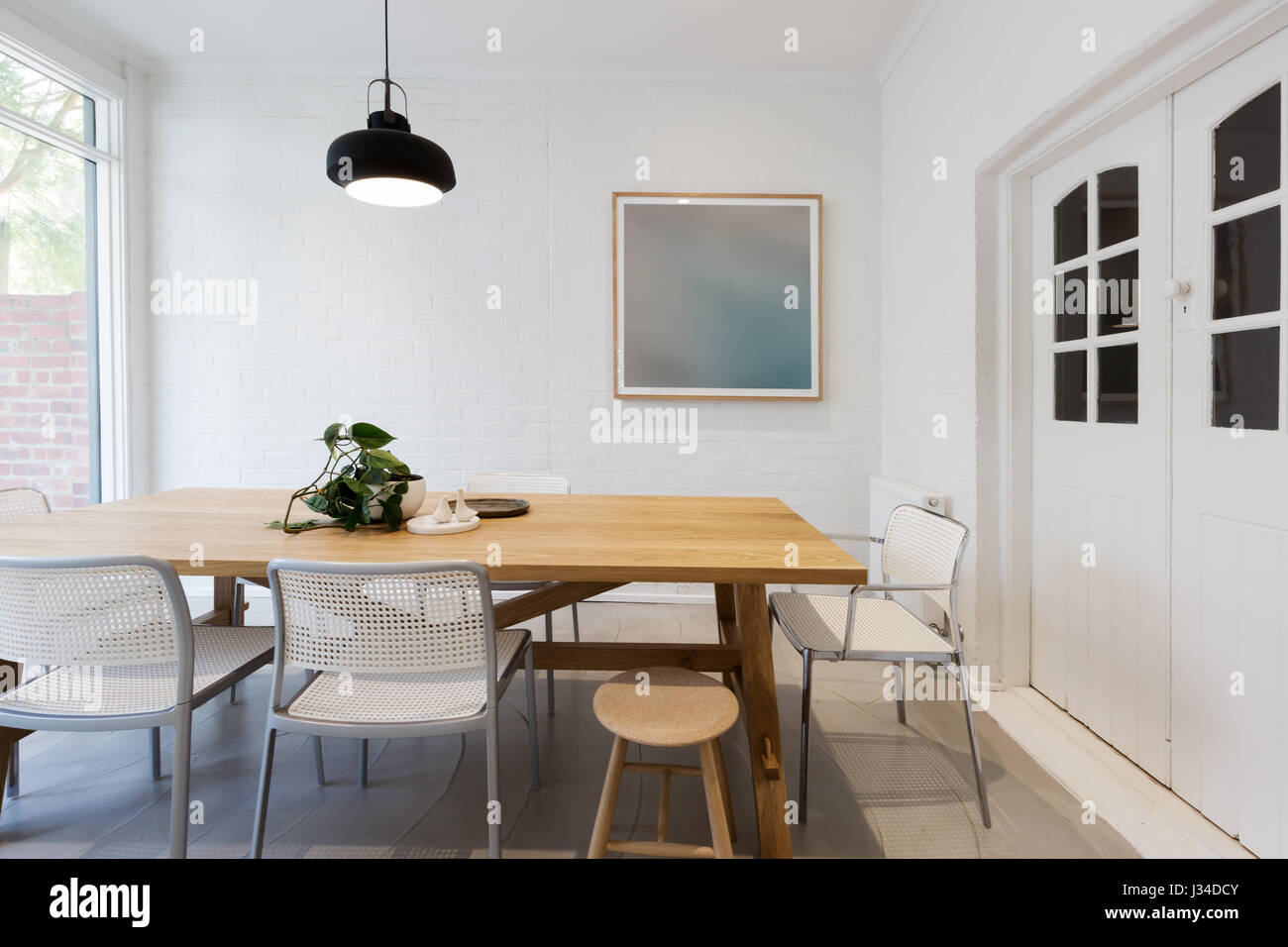 Modern scandinavian styled interior dining room with pendant light in Australia horizontal Stock Photo